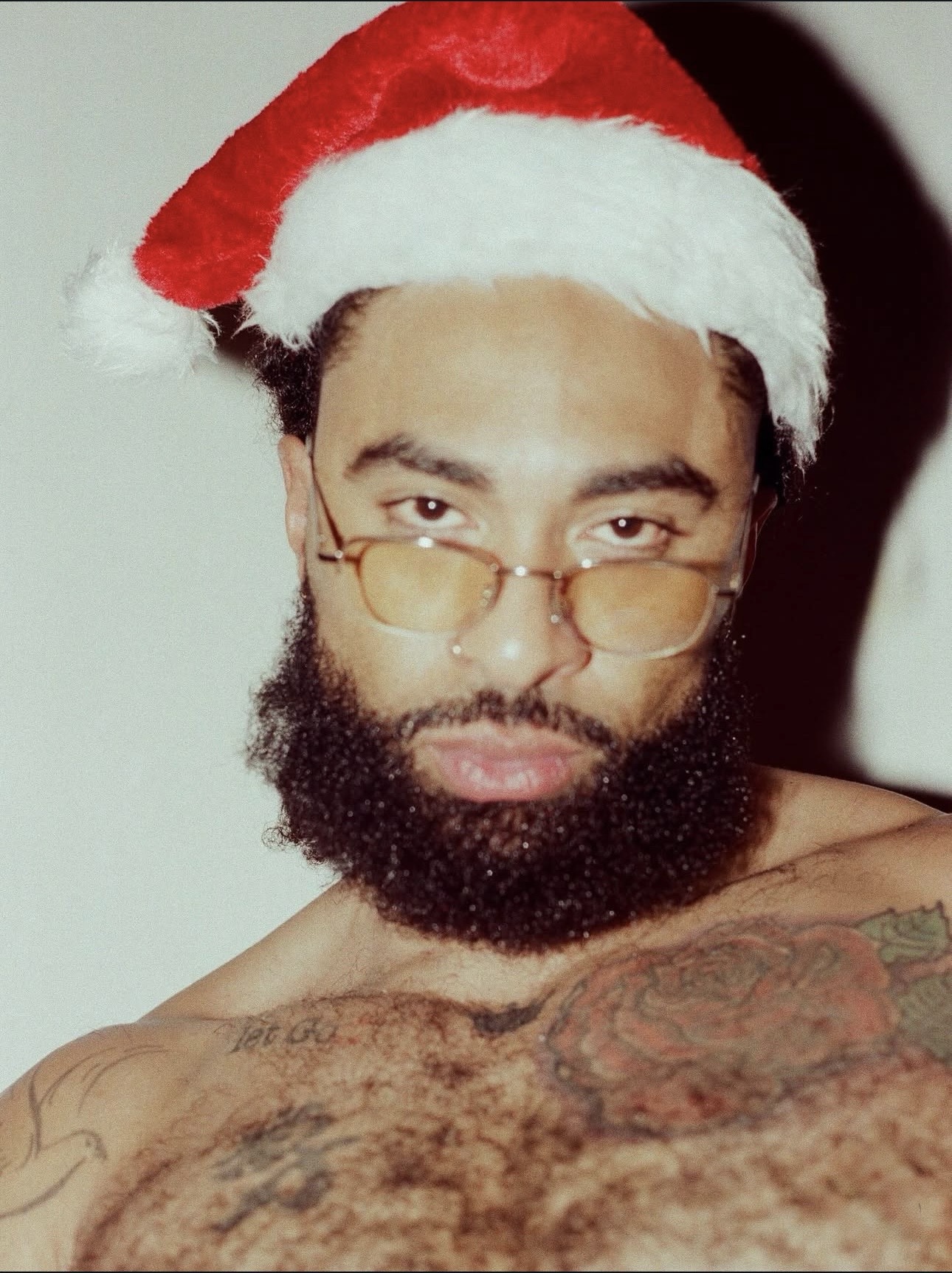LaShawn wearing a Santa hat and glasses in the CROTCH Christmas editorial