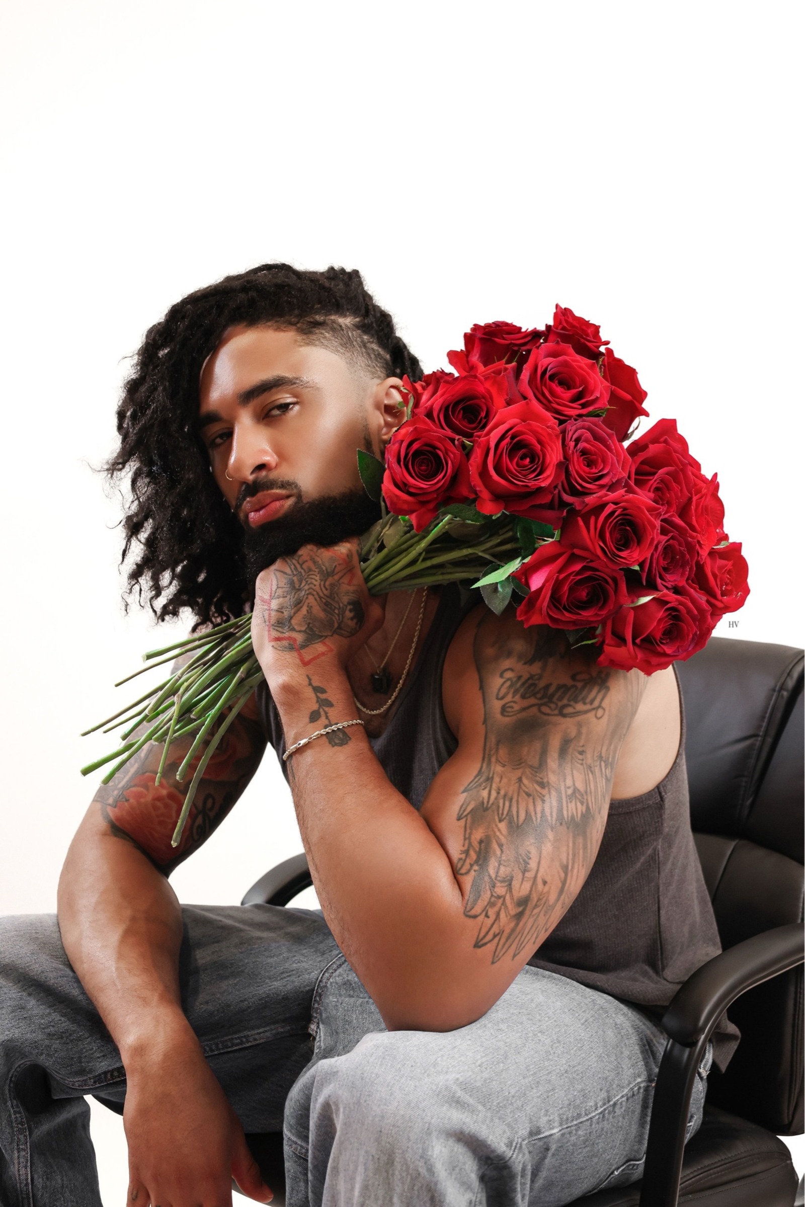 Portrait of LaShawn seated with red roses