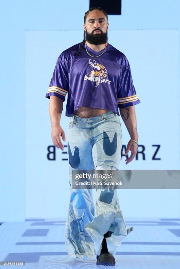 LaShawn on the BEILHARZ runway in a purple jersey and printed jeans; Ilya S. Savenok / Getty Images